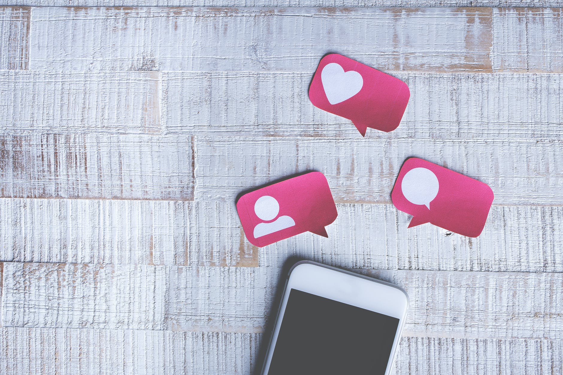 White smartphone, pink message icons