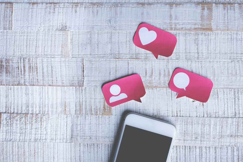White smartphone, pink message icons