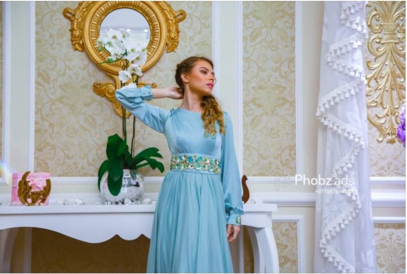 a girl posing in a blue dress