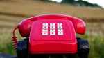 red old-fashioned landline phone with white buttons