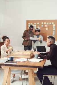 a group of people at the office by a table