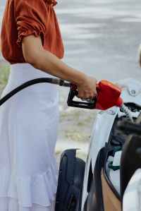 woman fills up her car with fuel